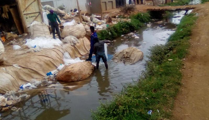 Maganda washing the plastic bags in a stream of water