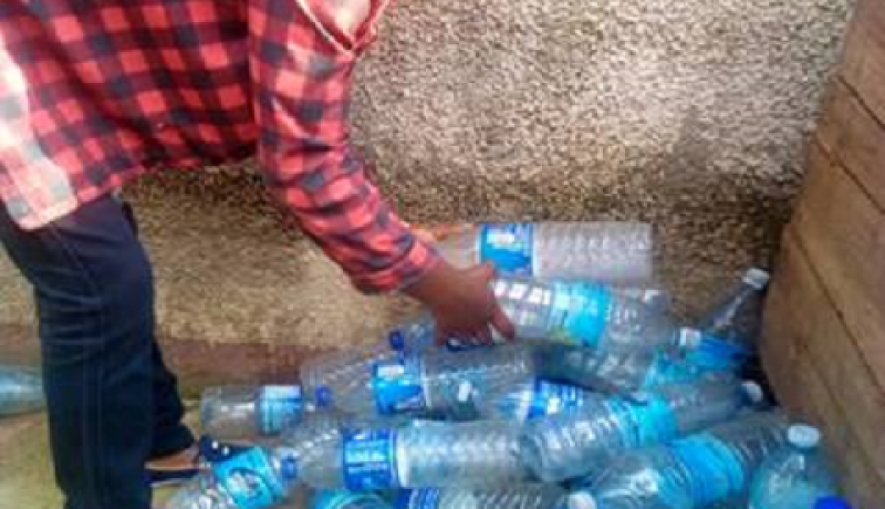 Kabuo Rose with the plastic bottles that she collected in Katwe
