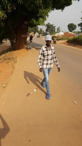 a picture of a young man whom I pictured throwing a plastic bottle on the road