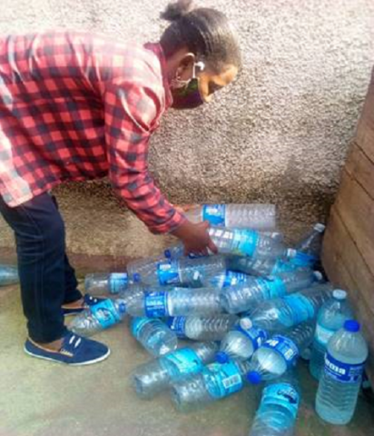 Kabuo Rose with the plastic bottles that she collected in Katwe